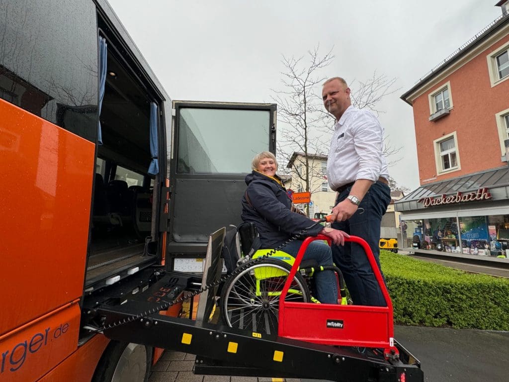 Debbie being helped off the bus by Sven