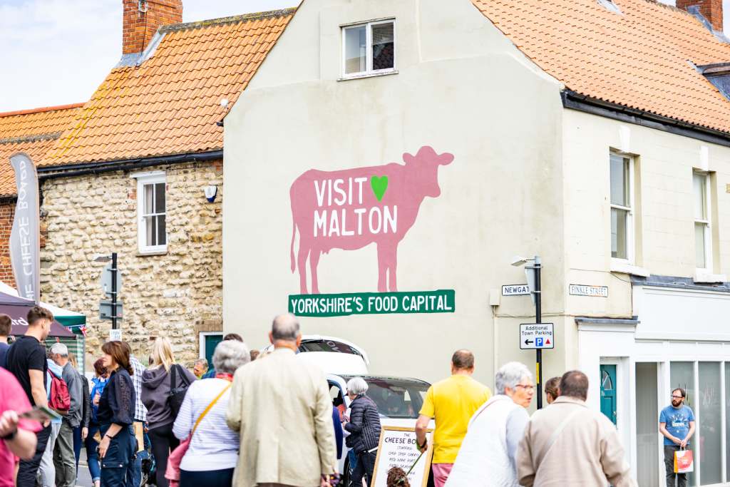 Visitors_VM Cow Mural_Malton Food Festival 3 June 2022. Photo Credit milnerCreative on behalf of Visit Malton