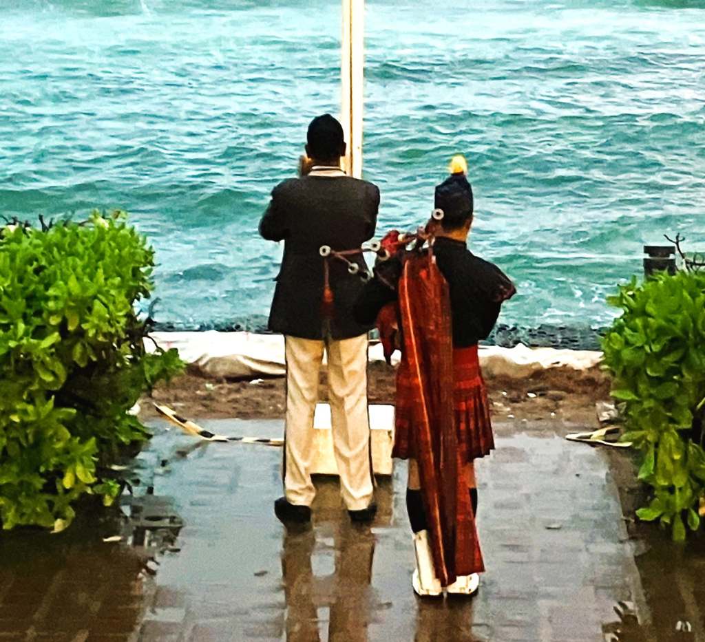 Lowering of the Sri Lankan flag to the accompaniment of a lone bagpiper