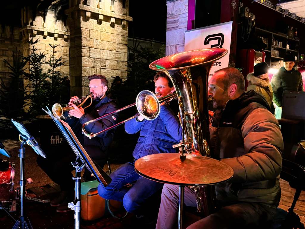 The Three Musketeers at the Hafenknistern Christmas market along the Landhafen in Klagenfurt