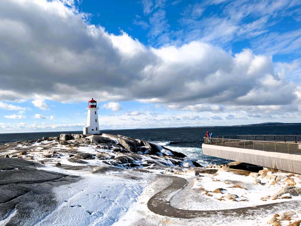 Jody and Mark opposite lighthouse in Peggy's Cove. Nova Scotia Road trip