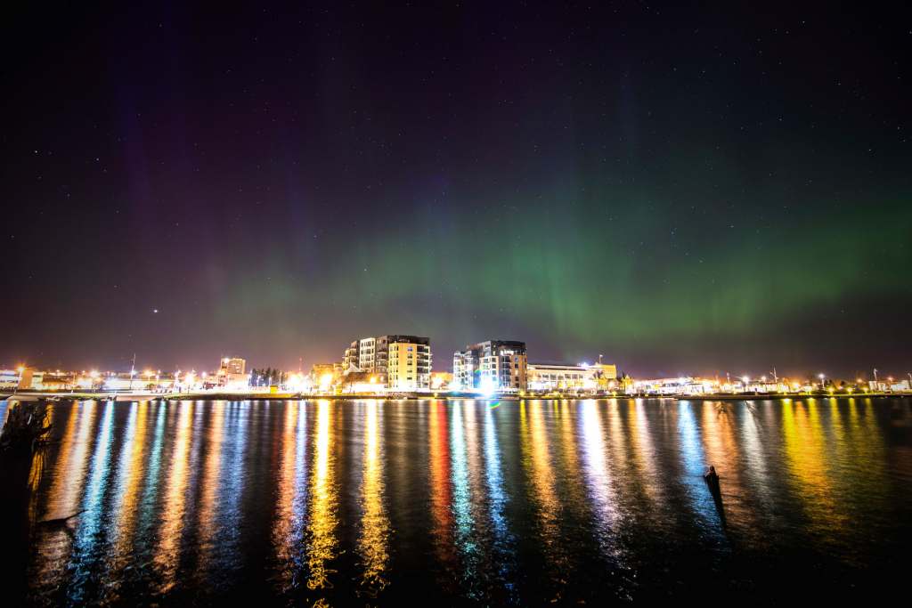 Northern lights City from water Photo Credit DayVid Z Photography