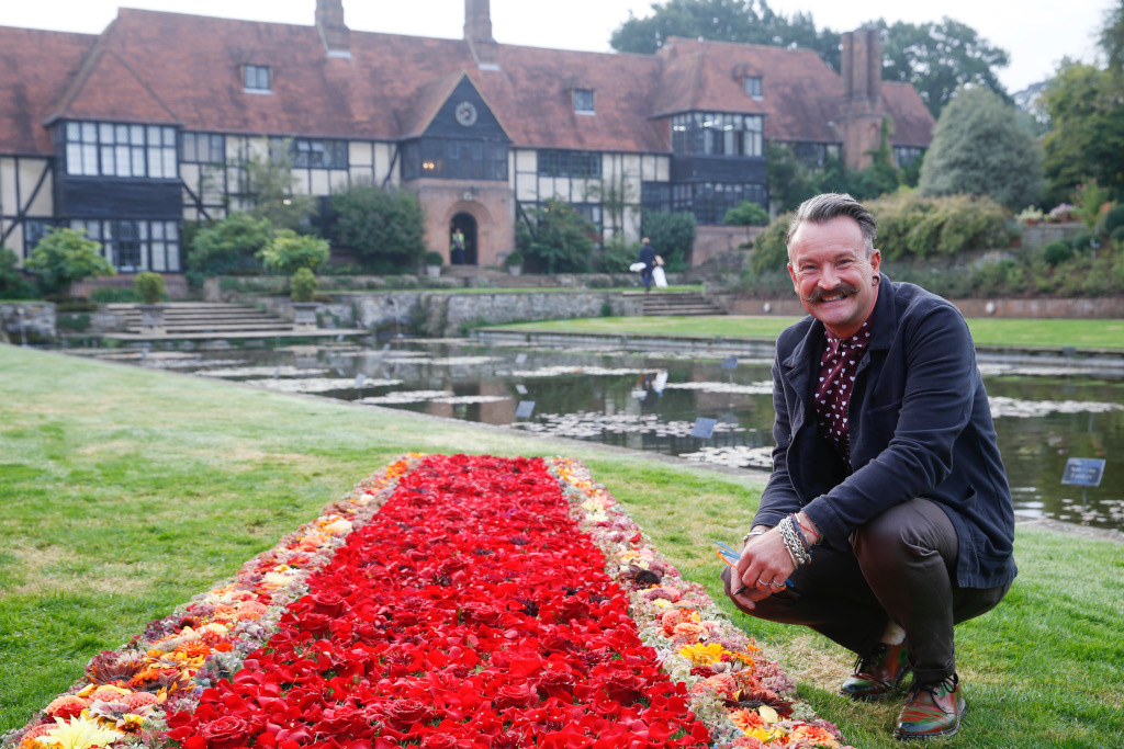 Floral designer Simon Lycett with his floral red carpet at RHS Garden Wisley Flower Show near Woking, Surrey, Tuesday September 4, 2018. The Hollywood style carpet was created by floral designer Simon Lycett and made of British grown locally sourced flowers. The show opens today and runs until September 9. RHS / Luke MacGregor